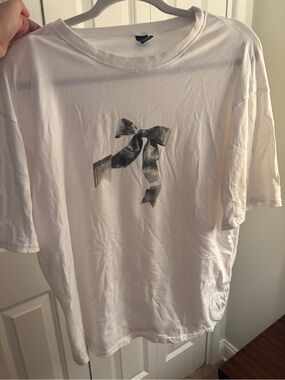 White woman’s  Crewneck T‑Shirt with Black Ribbon Graphic